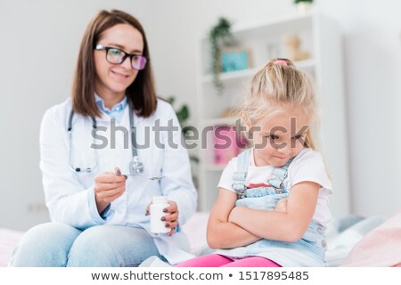 Stock foto: Naughty Sick Little Girl Turning Away From Doctor Giving Her Medicine