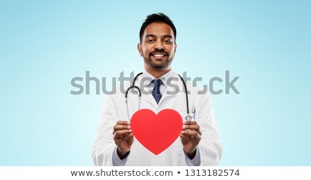 [[stock_photo]]: Smiling Indian Male Doctor With Red Heart Shape