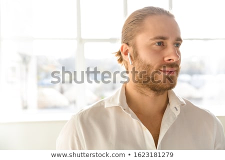 Stock photo: Photo Of Young Businessman Wearing White Shirt And Earpods In Ap