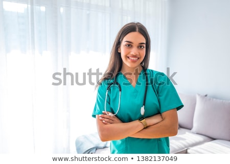 Zdjęcia stock: Doctors With Nurses With Arms Crossed In Hospital Corridor