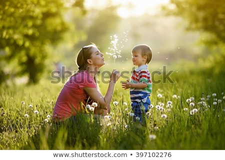 Сток-фото: Young Family Parents With Children Playing In A Field