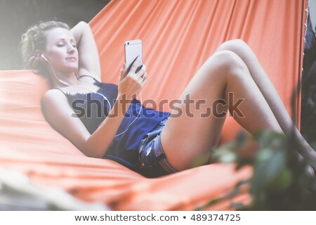 Stock photo: Girl Relaxing And Listening To Music In Hammock