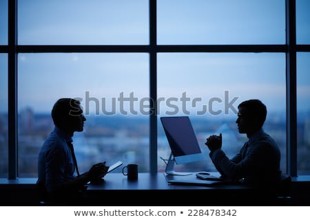 Silhouette Of A Man Working Late In The Office At The Computer Stockfoto © Pressmaster