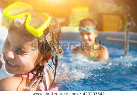 Stock photo: Two Children Playing In A Kiddie Pool