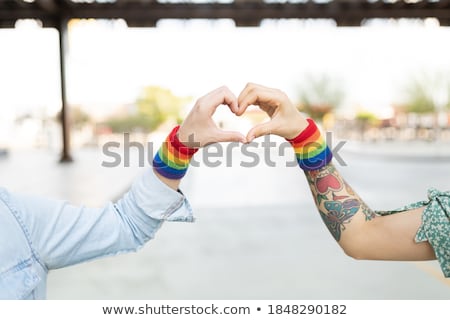 Stock fotó: Couple With Gay Pride Rainbow Wristbands And Heart