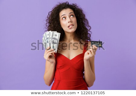 [[stock_photo]]: Image Of Charming Woman 20s Wearing Red Dress Holding Fan Of Mon