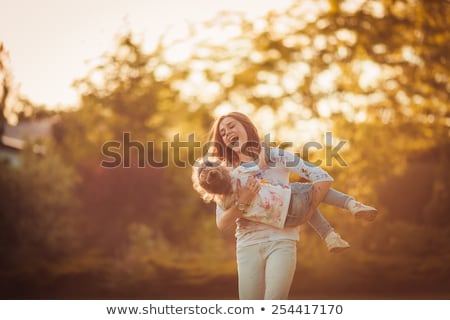 Stok fotoğraf: Happy Mother And Little Daughter At Autumn Park