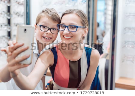 ストックフォト: Mother And Son Taking Selfie With New Glasses At Optometrist Shop
