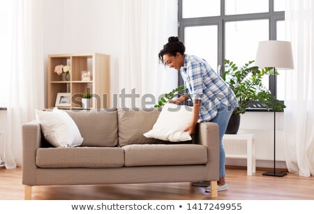 ストックフォト: African American Woman Arranging Sofa Cushions