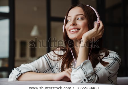 Stock photo: Listens And Smiles With Headphones