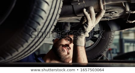 Foto stock: Mechanic Examining The Exhaust Of A Car