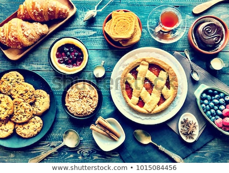 Stockfoto: Top View Of A Wood Table Full Of Cakes Fruits Coffee Biscuits