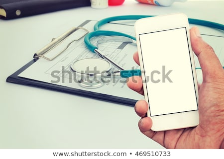 Stockfoto: Doctor Using Smartphone App In Hospital Office