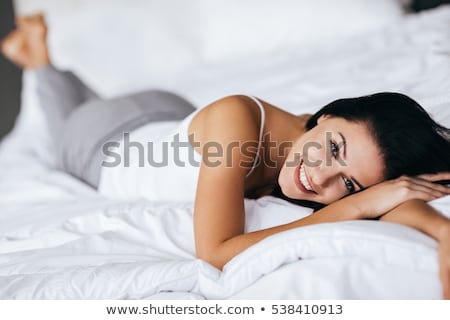 Сток-фото: Woman Lying In Bedroom Smiling