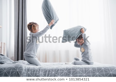 [[stock_photo]]: Kids Playing And Fighting By Pillows At Home