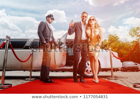 Foto d'archivio: Couple Arriving With Limousine Walking Red Carpet