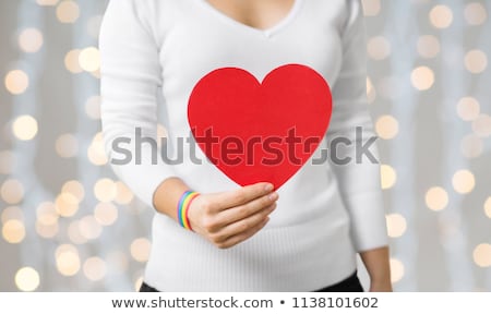 [[stock_photo]]: Woman With Gay Awareness Wristband Holding Heart