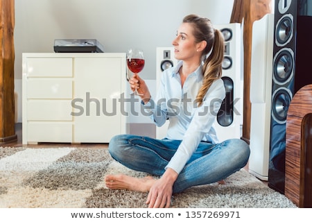Stockfoto: Woman Having Glass Of Wine In Front Of Hi Fi Speakers
