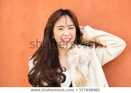 [[stock_photo]]: Optimistic Asian Young Woman With Orange