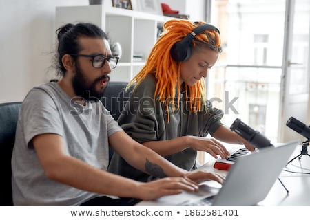 Foto d'archivio: Female Blogger With Headphones Making Video Blog