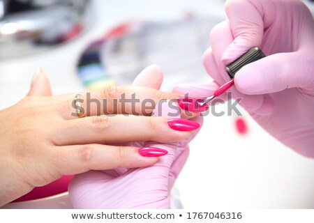 Foto stock: Woman Applying Nail Polish On Her Fingers