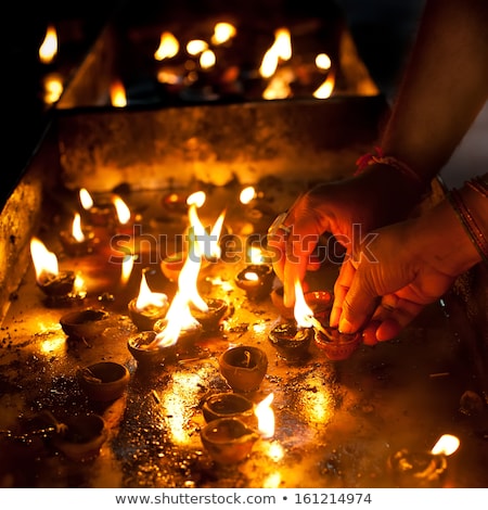 Zdjęcia stock: People Burning Oil Lamps As Religious Ritual In Hindu Temple