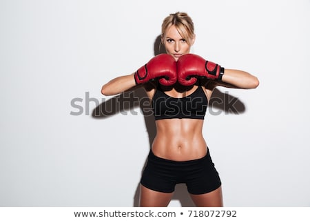 ストックフォト: Young Athletic Woman In Boxing Gloves On A White
