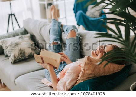 Foto stock: Woman Reads Book In A Bed