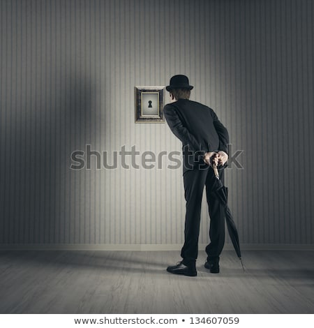 Stok fotoğraf: Businessman Spying Through The Keyhole