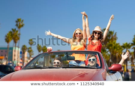 Stock fotó: Happy Young Woman In Convertible Car Over Beach