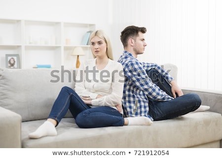 Stock photo: Depressed Couple Sitting On Sofa