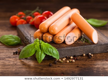 Foto d'archivio: Classic Boiled Meat Pork Sausages With Pepper And Basil And Cherry Tomatoes On White Background Mac