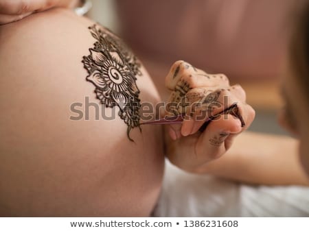 Stockfoto: The Pregnant Woman Belly With Henna Tattoo