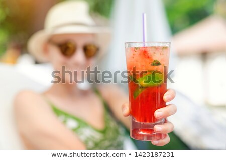 Stock photo: Woman Offering A Cocktail On The Beach As Refreshment