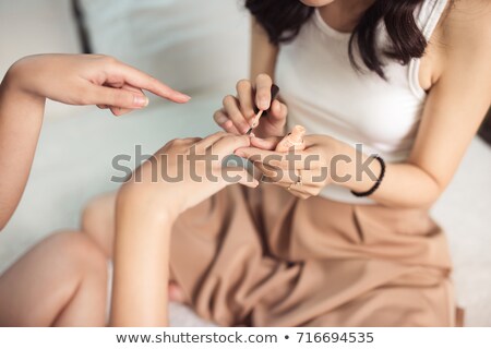 Stock photo: Asian Women Painting Nails In Bedroom