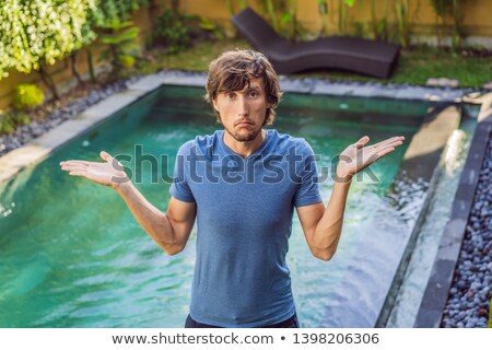 Foto d'archivio: Man Chooses Chemicals For The Pool Swimming Pool Service And Equipment With Chemical Cleaning Produ