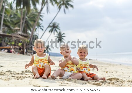 Stok fotoğraf: Three Baby Toddler Sitting On A Tropical Beach In Thailand Two Boys And One Girl