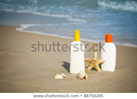 Suntan Lotion Flacons On The Beach With Copy Space Imagine de stoc © Taiga