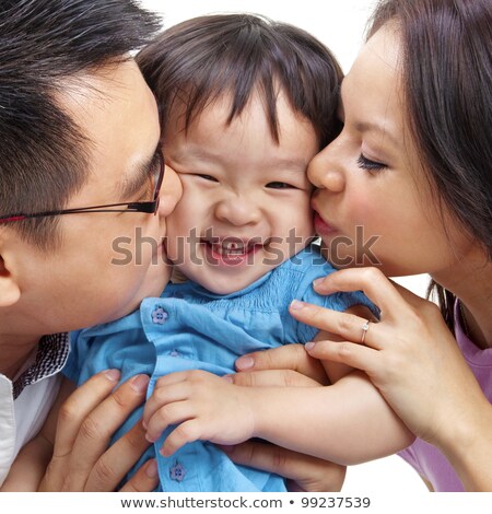 Parents Giving Their Daughter A Kiss Foto d'archivio © szefei