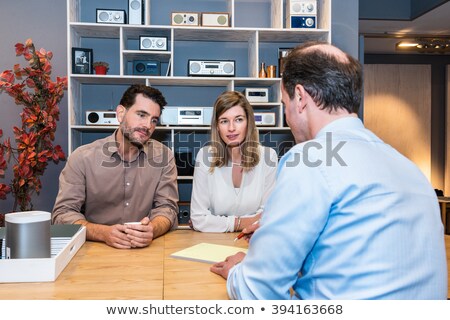ストックフォト: Couple Looking At Salesman Making Sale Receipt