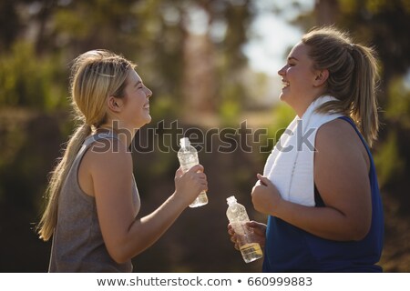 Stock fotó: Friends Interacting While Having Water After Workout During Obstacle Course