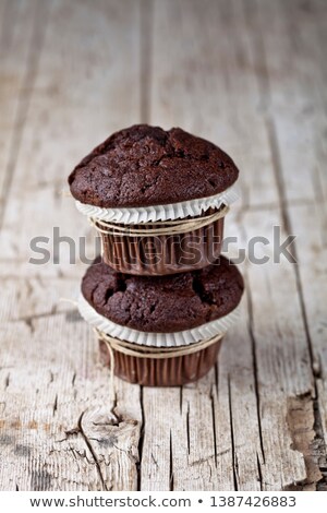 Stok fotoğraf: Two Dark Chocolate Dark Muffins On Rustic Wooden Table