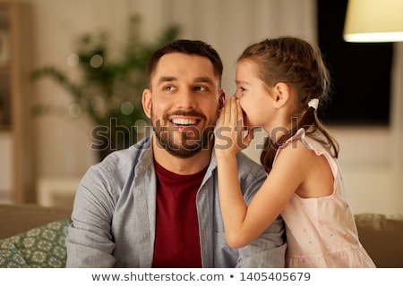 Сток-фото: Happy Daughter Whispering Secret To Father At Home