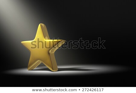 Foto stock: Gold Win In The Dark Illuminated By A Single Spotlight From Above Left