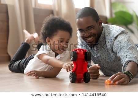 Stock photo: Boy Laying On Floor In Playroom