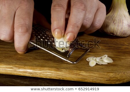 [[stock_photo]]: Female Hands Grind Garlic