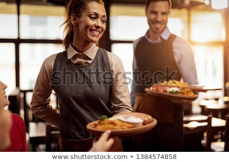 Stockfoto: Waiter Serving Food To Customers