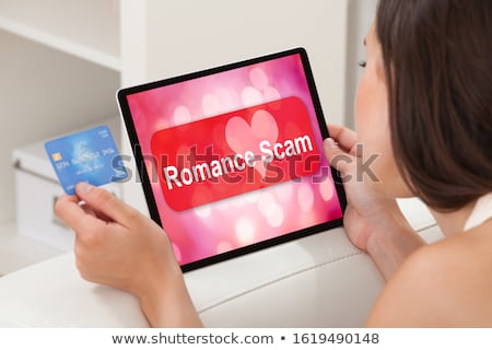 Stock fotó: Woman Using Laptop With Romance Scam Application On Screen