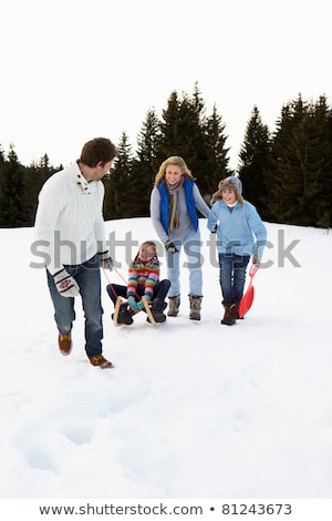 [[stock_photo]]: Young Family In Alpine Snow Scene With Sleds