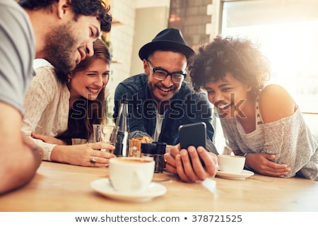 [[stock_photo]]: Women In Cafe Showing Pictures On Smart Phone